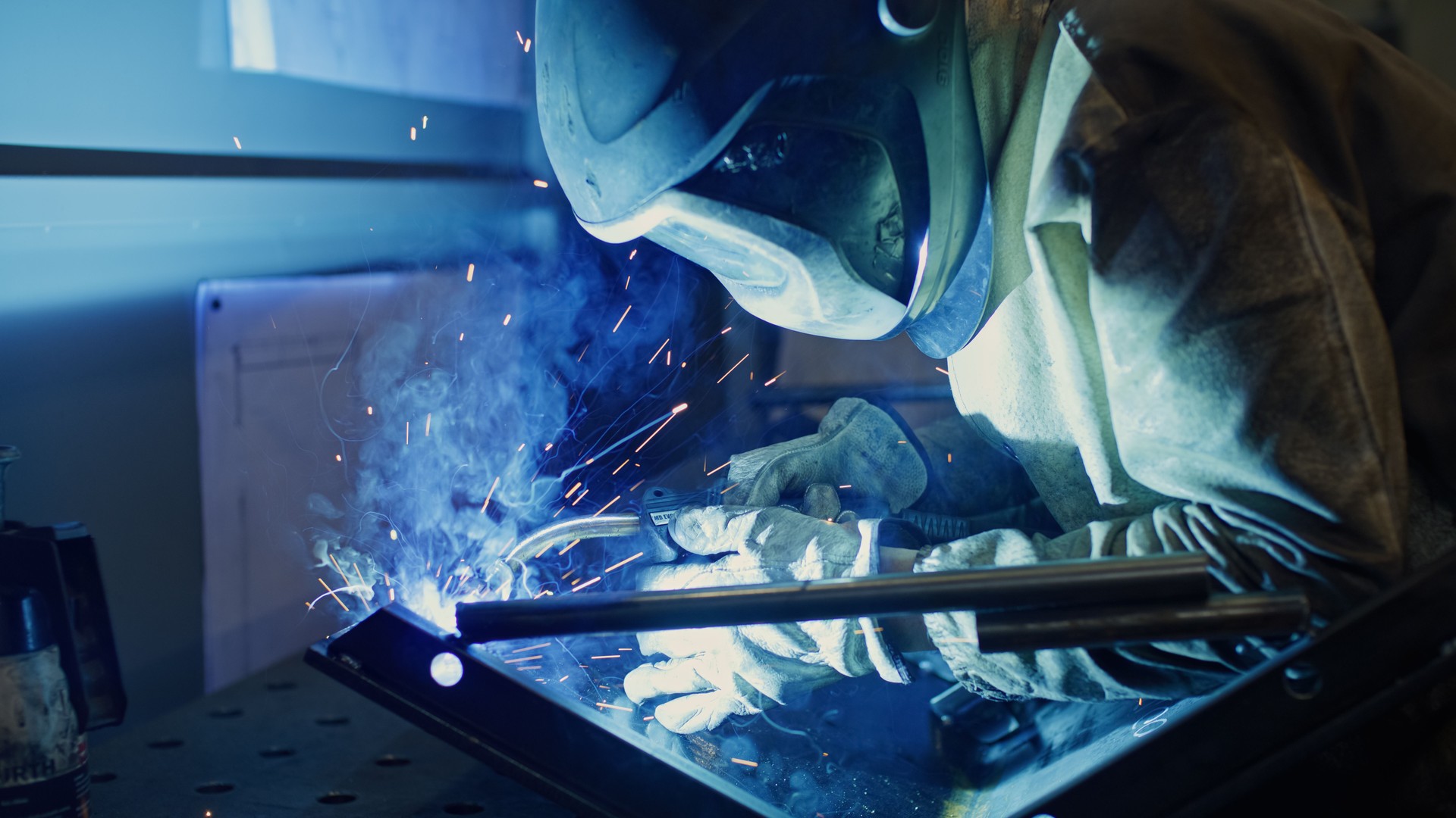 Industrial worker using welding machine at work